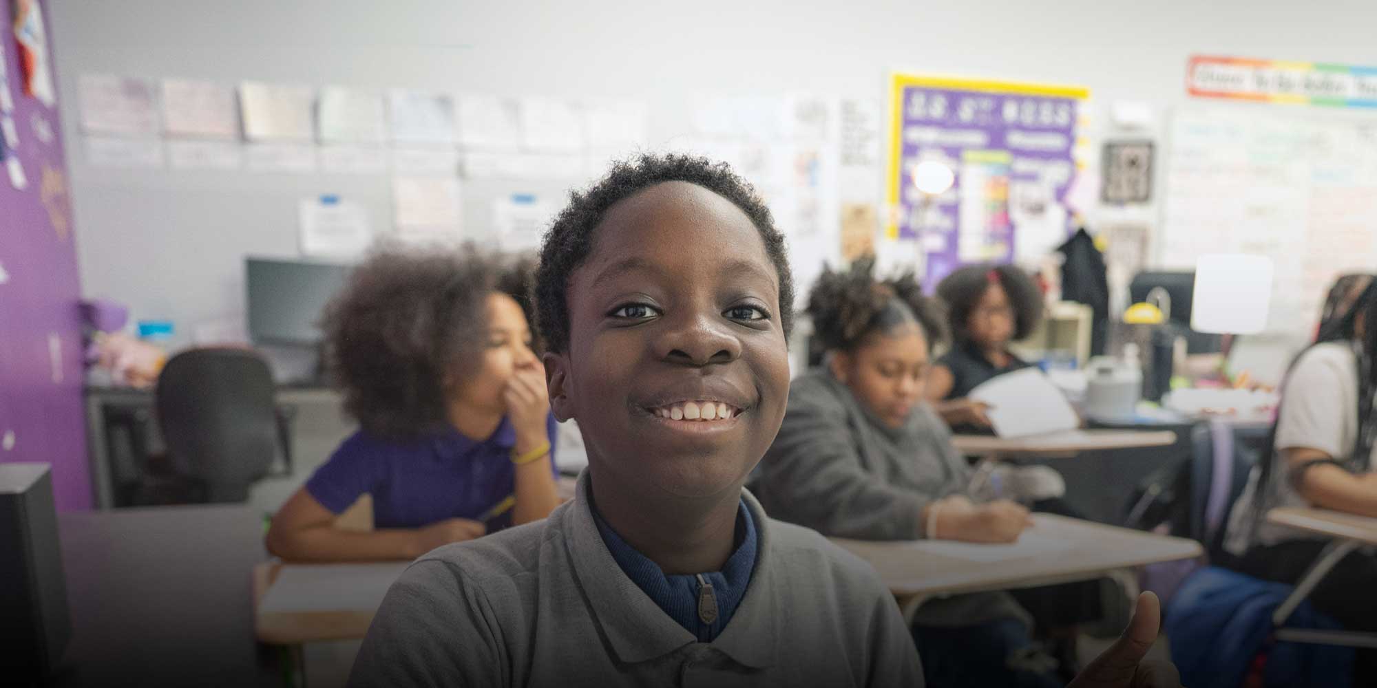 Smiling student sitting in class.